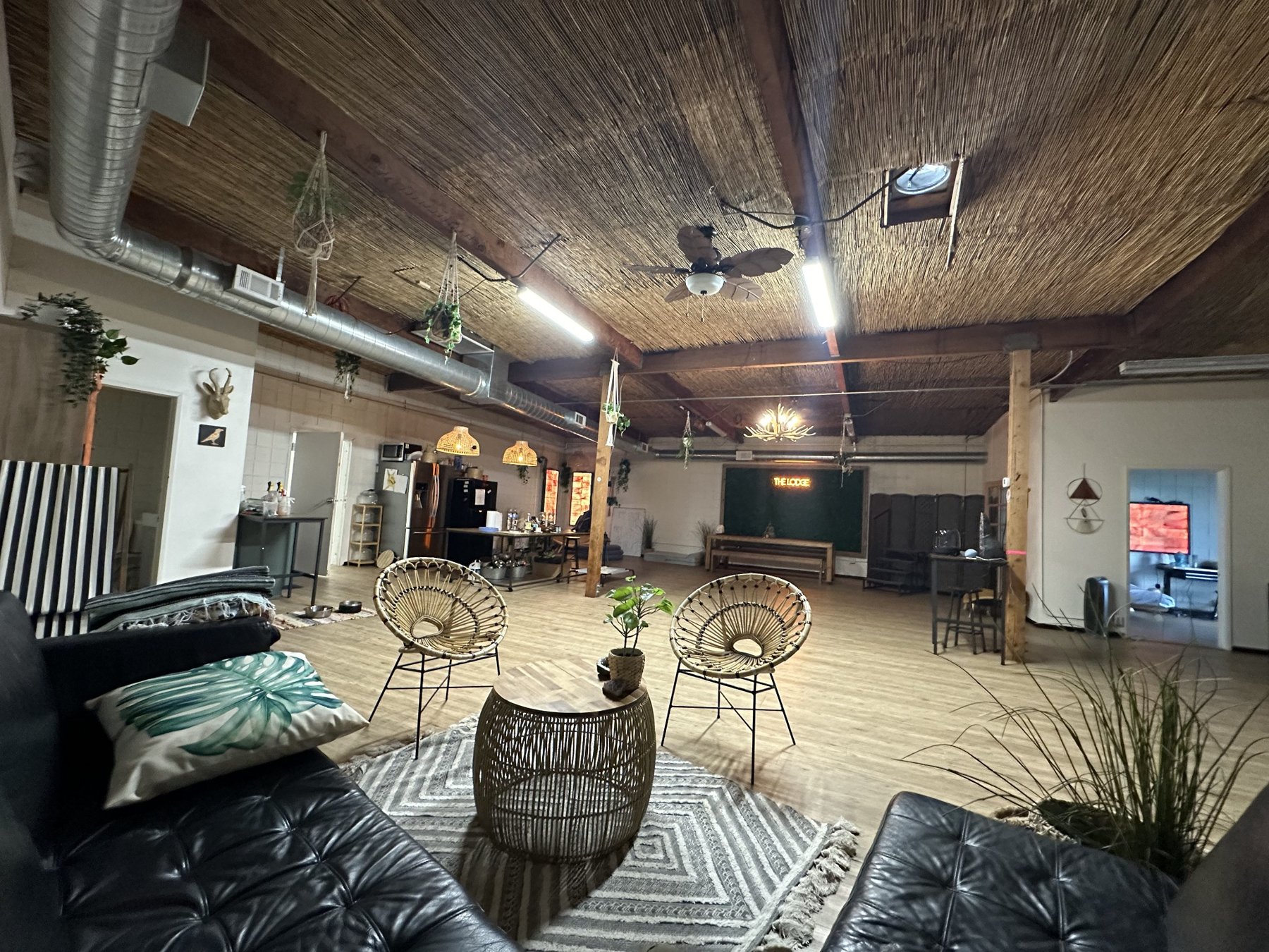 Spacious DEN Lodge open-concept indoor boarding lounge with warm natural furnishings