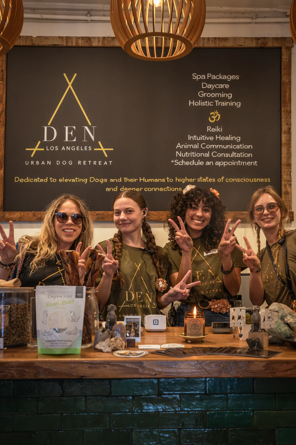 Friendly DEN Urban Dog Retreat team welcoming families at the dog social club and wellness campus in Los Angeles